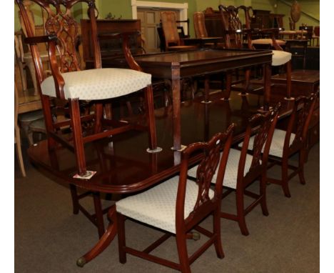 A George III style twin pedestal dining table (with two additional leaves) together with a set of eight Chippendale style din