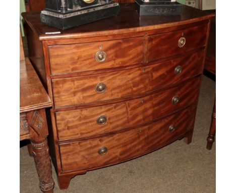 A George III mahogany, boxwood and ebony strung bowfront chest of drawers, early 19th century, of two short over three long d
