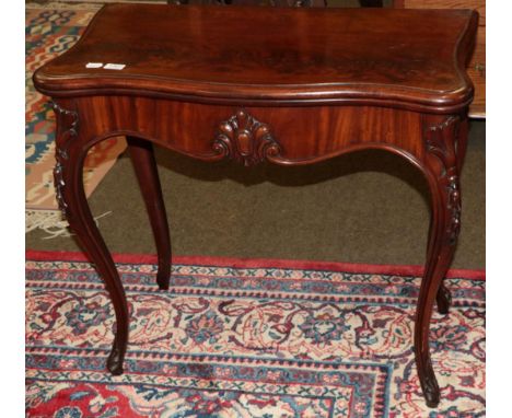 A Victorian mahogany fold over card table 