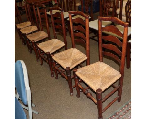A set of six oak ladder back rush seated dining chairs 