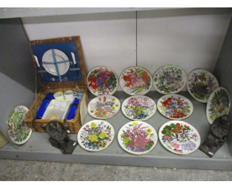 A set of twelve The Royal Horticultural Society Flower plates and a wicker hamper with contents 