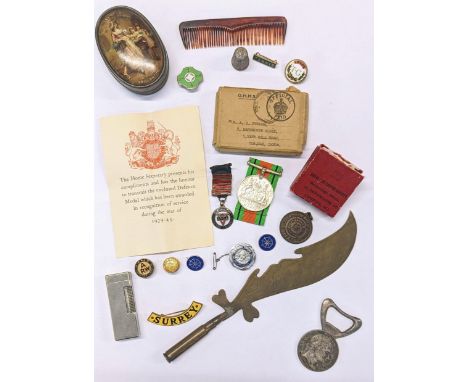 A mixed lot to include WWII British Defence medal, WWI trench art, mixed badges, Dunhill lighter a Napoleon commemorative bot