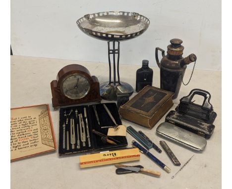 A mixed lot of items to include a silver plated tazza, hop flask, pens to include Parker fountain pen, an Elliot clock and ot