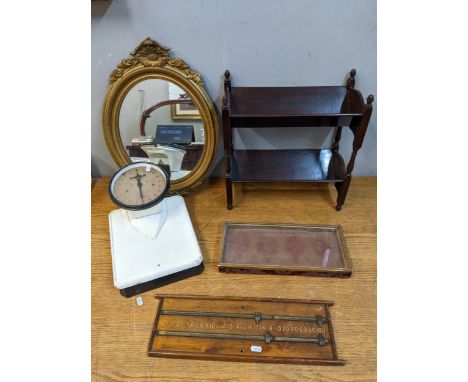 Decorative items to include a mahogany book trough, a gilt framed mirror, a display case, bathroom scales, and a snooker scor