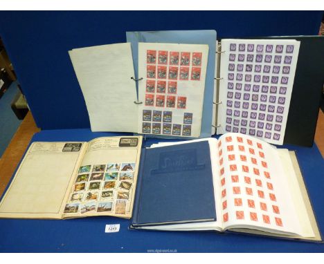 Four blue Stamp Albums containing English and Foreign stamps, an album of Queen Elizabeth stamps, etc.