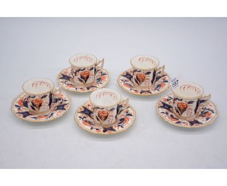 Five coffee cups and saucers by Coalport in Imari style colours.