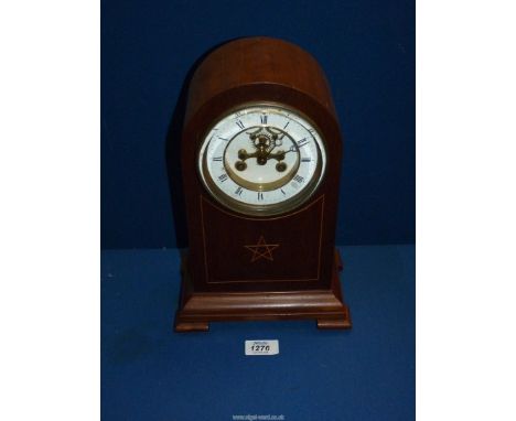 A domed top Mantle Clock, with bevelled glass and inlaid star motif on the front, and with a Brocot escapement, key and pendu