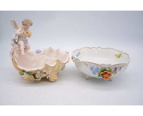 Two pieces of continental porcelain to include: a shell shaped dish with cherub perched on side of shell (as found) marked wi