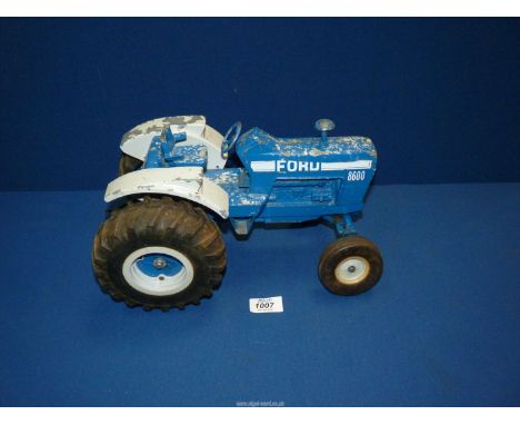 A large die-cast USA made model of a Ford 8600 tractor, 12 1/2" long x 7 1/2" tall.