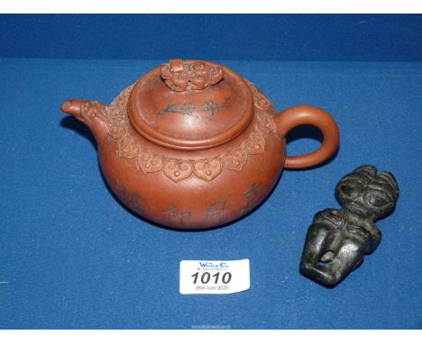 A Redware Yixing clay miniature Chinese teapot, with characters and beast finial, and a small carved stone figure of deity po