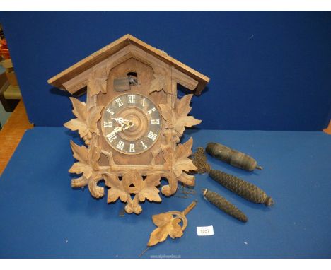 A large Black Forest type Cuckoo Clock, with three weights, 14" wide x 7 3/4" deep x 19 1/2" high including pendulum, (ran br