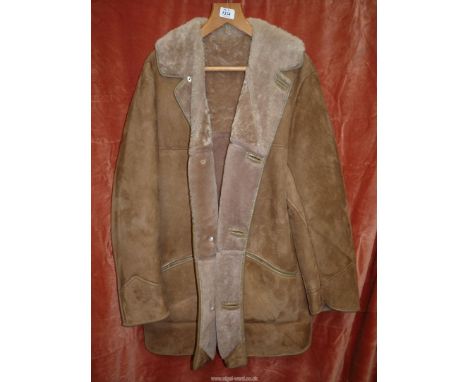 A gentleman's tan "Nurseys Sheepskin" coat size 42 with a spare button in pocket.