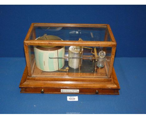 An Edwardian oak cased Barograph with glass panels and central drawer maker by Dixey Brighton, with presentation plaque, pres