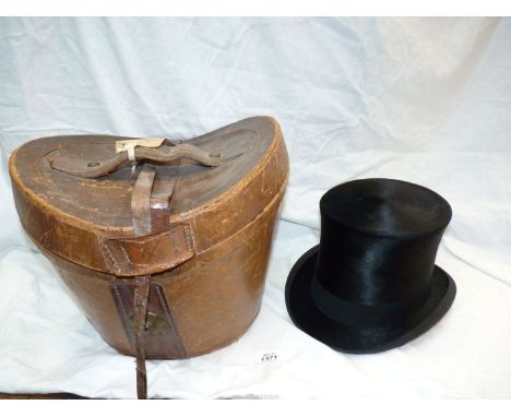 A G.M. Top Hat in leather hat box (as found)., 8'' front to back, 6 1/4'' side to side, 6'' high