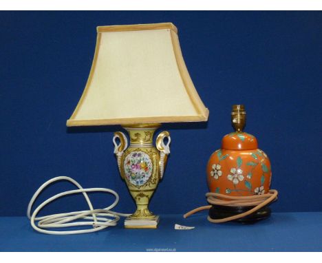 Two table Lamps, one of French porcelain with reserves illustrating stylised flower blooms, and having a square shade and the