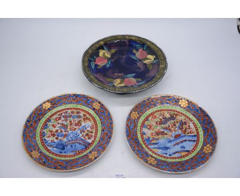 A pair of tin glaze Oriental Plates with brightly coloured floral decoration and stylized scrolling foliage to the undersides