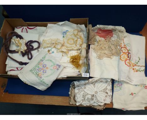 A quantity of embroidered tablecloths and lace doilies and patchwork quilt cover and pillow shams.