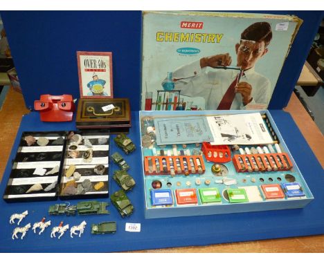 A number of miscellaneous toys to include: a vintage chemistry set, a money box, a small collection of Dinky and other milita