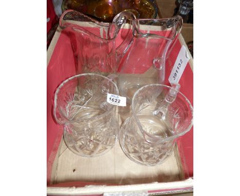 Four nice cut and plain glass water jugs.