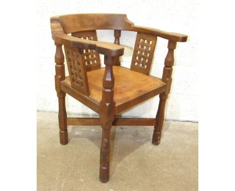 Robert 'Mouseman' Thompson Workshop, an English monk's chair, the curved back and outswept arms above three lattice-work pane