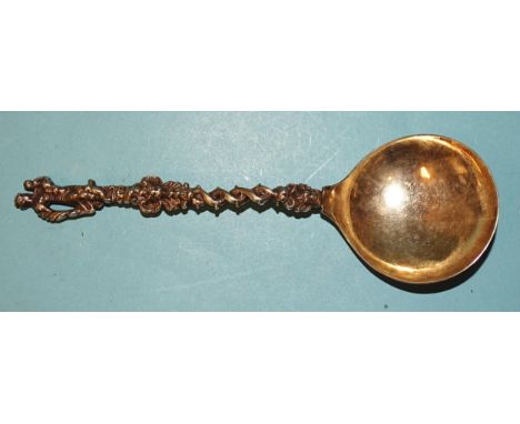 An 18th century Dutch cast silver-gilt spoon, the pierced twist handle with figure terminal, the bowl initialled F*R, 18cm lo