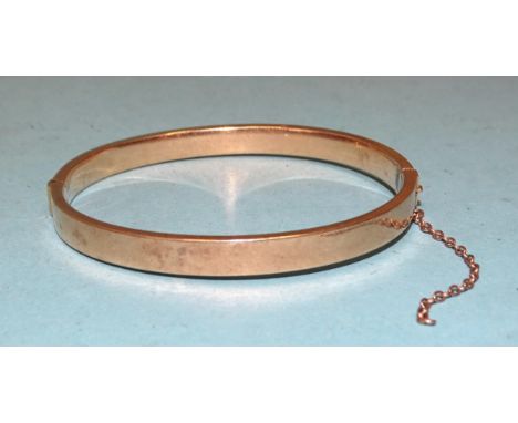 A 15ct gold hinged bangle, internal dimensions 57 x 49mm, 10g. 
