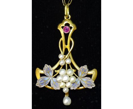 A French 18ct gold Art Nouveau pendant of sinuous form, collet-set a round-cut ruby above clusters of pearl 'grapes' between 
