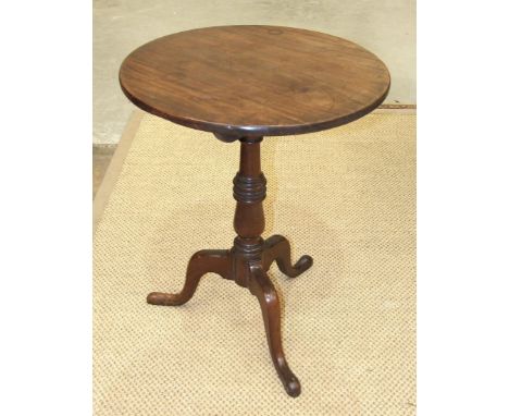 An 18th century mahogany tripod table, the circular top on turned column and tripod supports, 55cm diameter. 