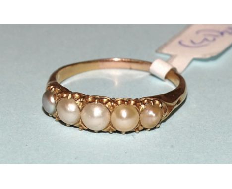 A Victorian yellow gold ring set five demi-pearls, unmarked, tested as 18ct gold approximately, size R, 3.4g. 