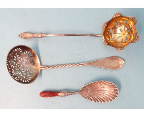 A Victorian silver-gilt sifter spoon, Martin &amp; Hall, Sheffield 1892, another with twisted stem, London 1933 and a caddy s