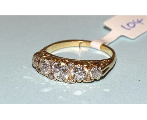 A Victorian five-stone diamond ring claw-set graduated old brilliant-cut diamonds, with 8/8-cut diamond points between, in 18
