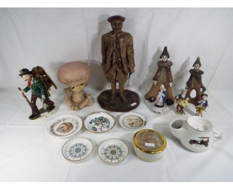 A good lot to include a figurine depicting an early golfer, a German figurine depicting a travelling knife sharpener, a Royal