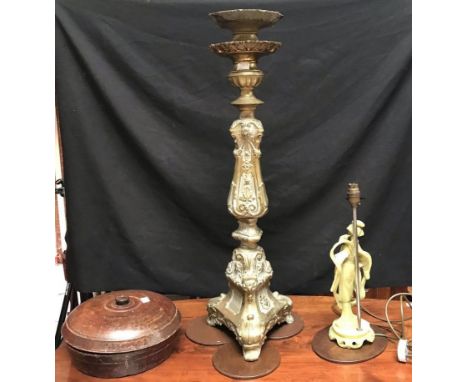 A large brass candlestick, ornately cast with scrolling foliage, raised on tripod support, together with an Oriental resin ta