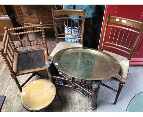 A painted bobbin corner chair and a pair of rush seated, oak standard chairs, together with a circular brass top folding tabl