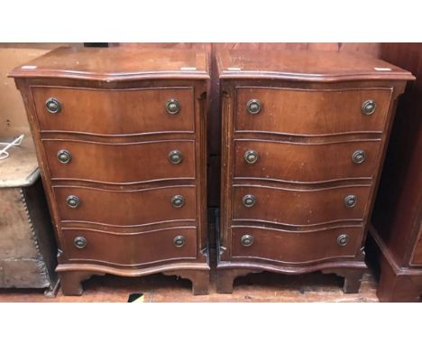 A pair of reproduction serpentine bedside chests of four drawers with brass ring pulls, raised on shaped bracket feet, 50cm w