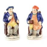 A PAIR OF COLOURFUL SEATED STAFFORDSHIRE TOBY JUGS depicting 'Tam o Shanter' and 'Souter Johnny'