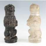 A PAIR OF 19TH CENTURY FRENCH MOULDED OPAQUE AND BLACK GLASS LIDDED JARS depicting seated dogs 31.