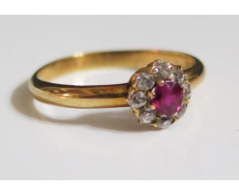 An 18ct Gold, Ruby and Diamond Cluster Ring, 7mm head, 3.5mm ruby, size N, 2.3g 