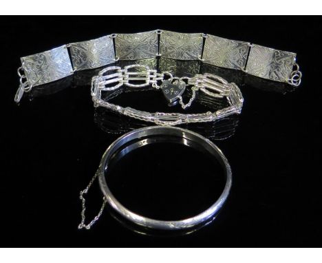 A Hinged Silver bangle with chased decoration, gate link silver bracelet and one other silver bracelet, 38g 