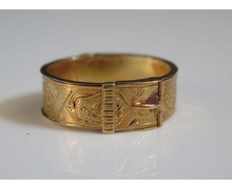 An Early 19th Century High Carat Gold Memorial Buckle Ring with twin hinges opening to a band of woven hair, mark to catch, s