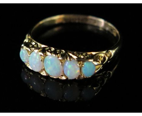 An 18ct Gold and White Opal Five Stone Ring, size O, 3.3g, boxed 