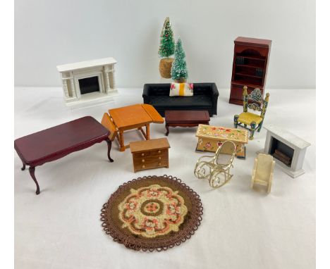 A quantity of dolls house furniture in varying scales. To include Chesterfield sofa, Christmas trees, dinning table, bookcase