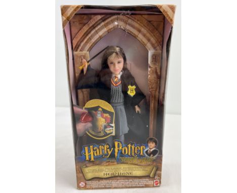 A boxed 2001 Mattel Warner Brothers Hermione 8" doll from the Harry Potter franchise. With Philosophers stone and magically a