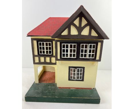 A small vintage Lines Bros Triang dolls house with car port, metal framed windows and a small collection of dolls house furni