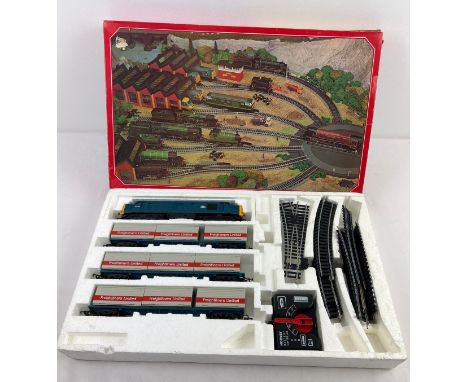 A boxed vintage Hornby Electronic Train Set R837-9130. Box contains diesel engine, 9 Freightliners Ltd wagons, track in varyi
