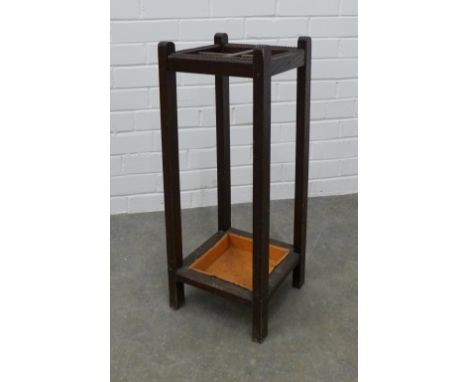 An Edwardian oak stick stand, four divisions and original drip tray . 67 x 26cm. 