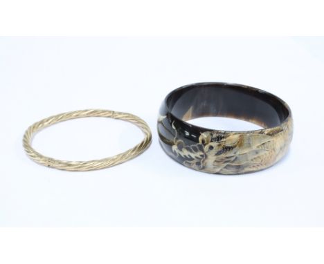 9ct gold stiff hinged bangle and a modern bangle with dragon pattern (2) 