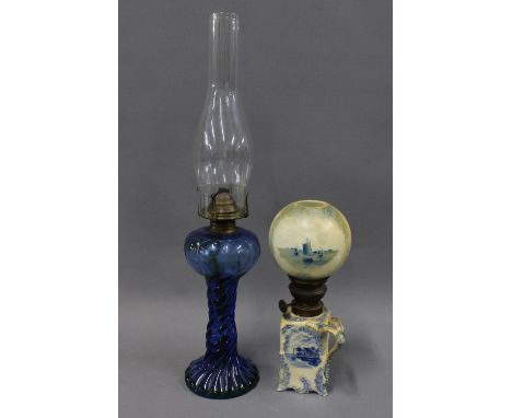 Blue glass oil lamp with glass funnel and a Delft blue and white lamp with globular shade, (2) 
