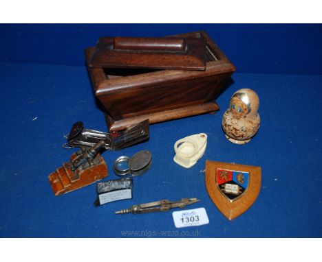 A Sarcophagus shaped Mahogany Box with miscellaneous items including a Russian doll, jeweller's loop, shrapnel from the first