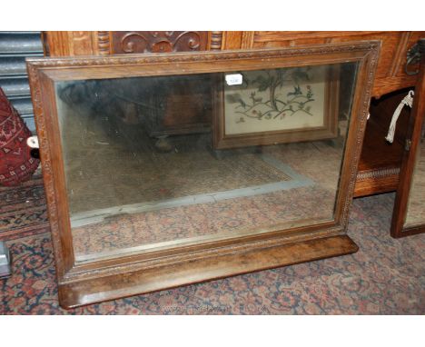 An Oak framed Mirror with shelf under, 34'' x 23''.